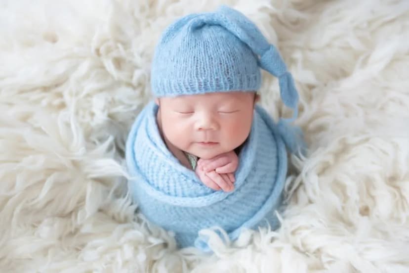 Newborn studio portrait in a swaddle