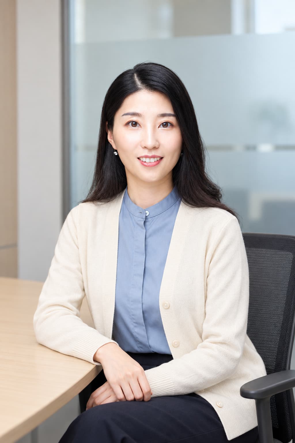 Female colleague seated in a bright office